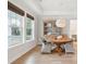Bright dining room features hardwood floors, a rustic wood table, and large windows for natural light at 1604 Bernier Commons, Johns Island, SC 29455
