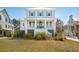 Charming two-story home with a porch, a white fence and a well manicured yard at 1604 Bernier Commons, Johns Island, SC 29455