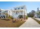 Charming two-story coastal home with a welcoming front porch, landscaped yard, and a private driveway at 1604 Bernier Commons, Johns Island, SC 29455