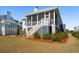 Screened porch with stairs, white railings, and a view of the grassy backyard and neighboring house at 1604 Bernier Commons, Johns Island, SC 29455