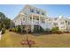 Charming two-story coastal home with a large front porch, white railings, and a well-manicured lawn at 1604 Bernier Commons, Johns Island, SC 29455