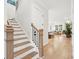 Light-filled hallway leads to a staircase and a glimpse of the open-concept living area at 1604 Bernier Commons, Johns Island, SC 29455
