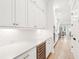 Long kitchen view featuring expansive counters, sleek cabinets, and a wine cooler at 1604 Bernier Commons, Johns Island, SC 29455