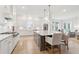 Bright, open kitchen with a large island, white cabinets, and stainless steel appliances at 1604 Bernier Commons, Johns Island, SC 29455