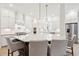 Open-concept kitchen features an island with chairs, stainless steel appliances, and white cabinetry at 1604 Bernier Commons, Johns Island, SC 29455