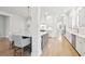 Open-concept kitchen featuring white cabinets, stone countertops, stainless appliances, and a central island at 1604 Bernier Commons, Johns Island, SC 29455