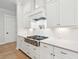 Gourmet kitchen boasts stainless steel appliances, a pot filler, and stylish white cabinetry at 1604 Bernier Commons, Johns Island, SC 29455