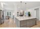 Open kitchen with large island and pendant lighting has stainless appliances and ample storage at 1604 Bernier Commons, Johns Island, SC 29455