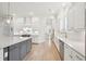 Modern kitchen featuring white cabinets, stone countertops, stainless appliances, and a central island at 1604 Bernier Commons, Johns Island, SC 29455