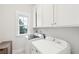 Functional laundry room with white cabinets, washer, and dryer at 1604 Bernier Commons, Johns Island, SC 29455