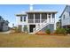 The rear exterior features a screened porch, stairs, and a well-maintained lawn at 1604 Bernier Commons, Johns Island, SC 29455