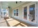 A screened porch features wood flooring, ceiling fans, and views of the outdoors at 1604 Bernier Commons, Johns Island, SC 29455