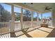 A screened porch has outdoor seating, ceiling fans, and views of the surrounding landscape at 1604 Bernier Commons, Johns Island, SC 29455