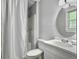 Bright bathroom featuring a white vanity, toilet, tub/shower combo and a round mirror at 166 Braly Dr, Summerville, SC 29485