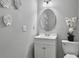 Bathroom features a white vanity, toilet, and decorative floral arrangement on the tank at 166 Braly Dr, Summerville, SC 29485