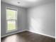 Empty bedroom showcasing hardwood floors, a window, and light gray walls at 166 Braly Dr, Summerville, SC 29485