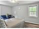 Comfortable bedroom with a bed, two blue armchairs, hardwood floors, and natural light from the window at 166 Braly Dr, Summerville, SC 29485