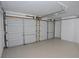 Large garage featuring two roll-up doors and a clean, bright interior ready for vehicles and storage at 166 Braly Dr, Summerville, SC 29485