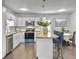 Open-concept kitchen and dining area with stainless steel appliances, granite counters, and a dining table at 166 Braly Dr, Summerville, SC 29485