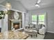 Stylishly decorated living room with a cozy fireplace open to kitchen, hardwood floors and natural light at 166 Braly Dr, Summerville, SC 29485