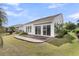 A backyard featuring a brick patio and a white exterior with sliding glass doors under an awning at 170 Sea Lavender Ln, Summerville, SC 29486
