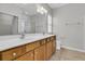 Bathroom featuring dual sinks and a glass-enclosed shower, offering both style and functionality at 170 Sea Lavender Ln, Summerville, SC 29486