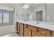 Bathroom featuring double sinks, a large mirror, and ample cabinet space, conveniently located near the bedroom at 170 Sea Lavender Ln, Summerville, SC 29486