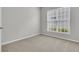 Bright bedroom featuring a large window and neutral walls and carpet at 170 Sea Lavender Ln, Summerville, SC 29486