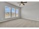 Bright bedroom features three large windows, neutral walls, and a ceiling fan, offering a cozy and airy space at 170 Sea Lavender Ln, Summerville, SC 29486