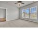 A spacious bedroom with neutral tones, large windows, and a ceiling fan provides a blank canvas for personalization at 170 Sea Lavender Ln, Summerville, SC 29486