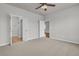 Well-lit bedroom with carpet, a ceiling fan, and multiple doorways leading to a bathroom and other rooms at 170 Sea Lavender Ln, Summerville, SC 29486