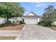 The home features a clean two car garage and neutral paint, complemented by mature trees at 170 Sea Lavender Ln, Summerville, SC 29486