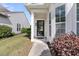 Inviting front entryway with a black door and glass window, framed by white columns and lush landscaping at 170 Sea Lavender Ln, Summerville, SC 29486