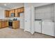 Kitchen area with stainless steel appliances, wooden cabinets and a laundry area with a washer and dryer at 170 Sea Lavender Ln, Summerville, SC 29486