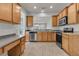 Open kitchen with stainless steel appliances and wood cabinets overlooking a dining area with natural light at 170 Sea Lavender Ln, Summerville, SC 29486