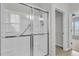 Bathroom features a shower with glass doors, a grab bar, and adjustable shower head at 170 Sea Lavender Ln, Summerville, SC 29486