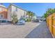 Exterior view of a residential property with a gravel driveway and parking area, enclosed by a wooden fence at 172 Saint Philip St # F, Charleston, SC 29403