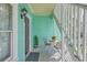 Inviting balcony features seating, plants, and light-blue siding at 172 Saint Philip St # F, Charleston, SC 29403
