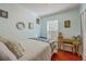 Well-lit bedroom featuring a bed, desk with vintage chair, and ample natural light, creating a warm and inviting space at 172 Saint Philip St # F, Charleston, SC 29403