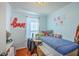 Cozy bedroom with a twin bed, a built-in desk area, and natural light from the window at 172 Saint Philip St # F, Charleston, SC 29403