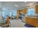 Bright kitchen featuring wooden cabinets, stainless steel appliances, and an open layout connecting to the living area at 172 Saint Philip St # F, Charleston, SC 29403