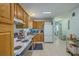 Charming kitchen with wooden cabinets, white appliances, and durable flooring, offering a functional space at 172 Saint Philip St # F, Charleston, SC 29403