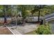Outdoor basketball court with wooden walkway surrounded by trees and view of decorative fountain behind white fence at 188 Midlands Pkwy # 507, Summerville, SC 29485