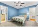 Serene bedroom with blue walls, ceiling fan, and ensuite bath access, creating a tranquil and private oasis at 188 Midlands Pkwy # 507, Summerville, SC 29485