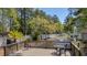 Wooden deck with table and chairs overlooking pond with fountain surrounded by lush greenery at 188 Midlands Pkwy # 507, Summerville, SC 29485