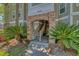 Condo entrance with brick archway, stairs, and vibrant palm trees, creating a welcoming atmosphere at 188 Midlands Pkwy # 507, Summerville, SC 29485