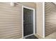 Close-up of condo unit's front door featuring sleek black color and modern hardware at 188 Midlands Pkwy # 507, Summerville, SC 29485