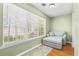 Cozy sitting area with a plush armchair, ottoman, and a view of outdoor landscape through window at 188 Midlands Pkwy # 507, Summerville, SC 29485