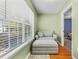 Bright sitting area featuring a comfortable armchair, ottoman, and a scenic view through the window at 188 Midlands Pkwy # 507, Summerville, SC 29485