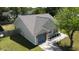 Aerial view of a charming home featuring a gray roof, blue garage door, and well-maintained landscaping at 203 Two Hitch Rd, Goose Creek, SC 29445